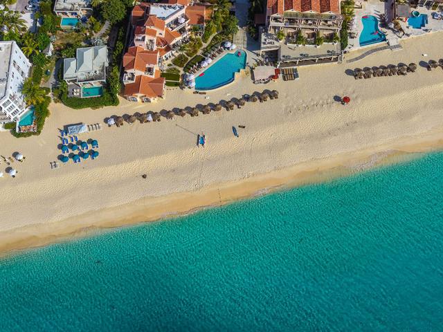 Aerial view of a beachfront resort on turquoise water